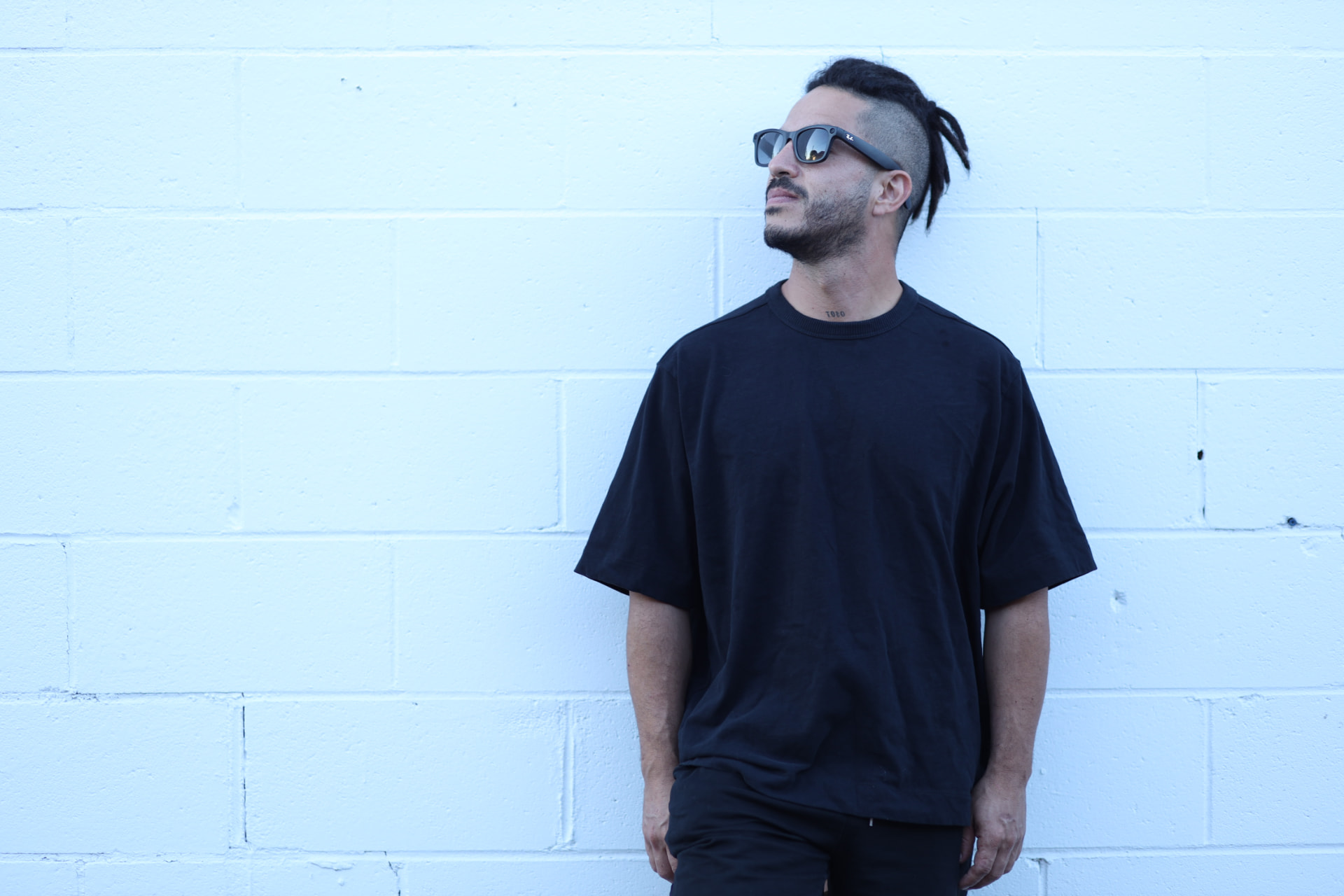 TOBO — Gilberto Torres against a white brick wall