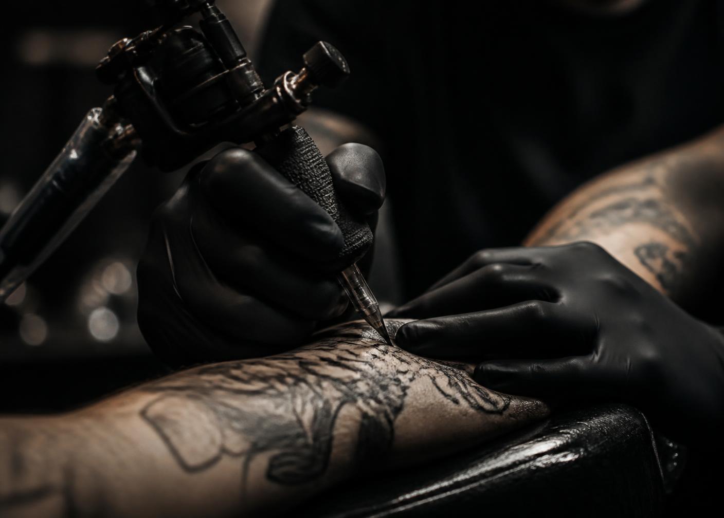 Tattoo session in progress in a dark private studio